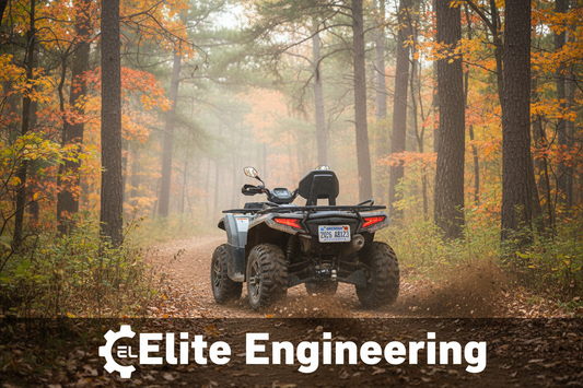ATV with white license plate riding on a Wisconsin woodland trail with pine trees and fall foliage in the background