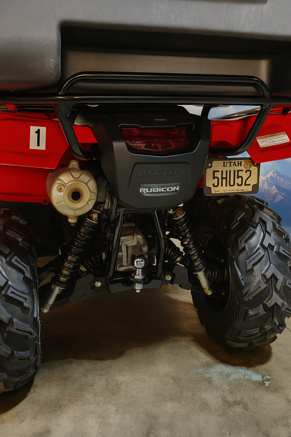 Back view of a red off-road vehicle with 'Rubicon' branding on a concrete floor.